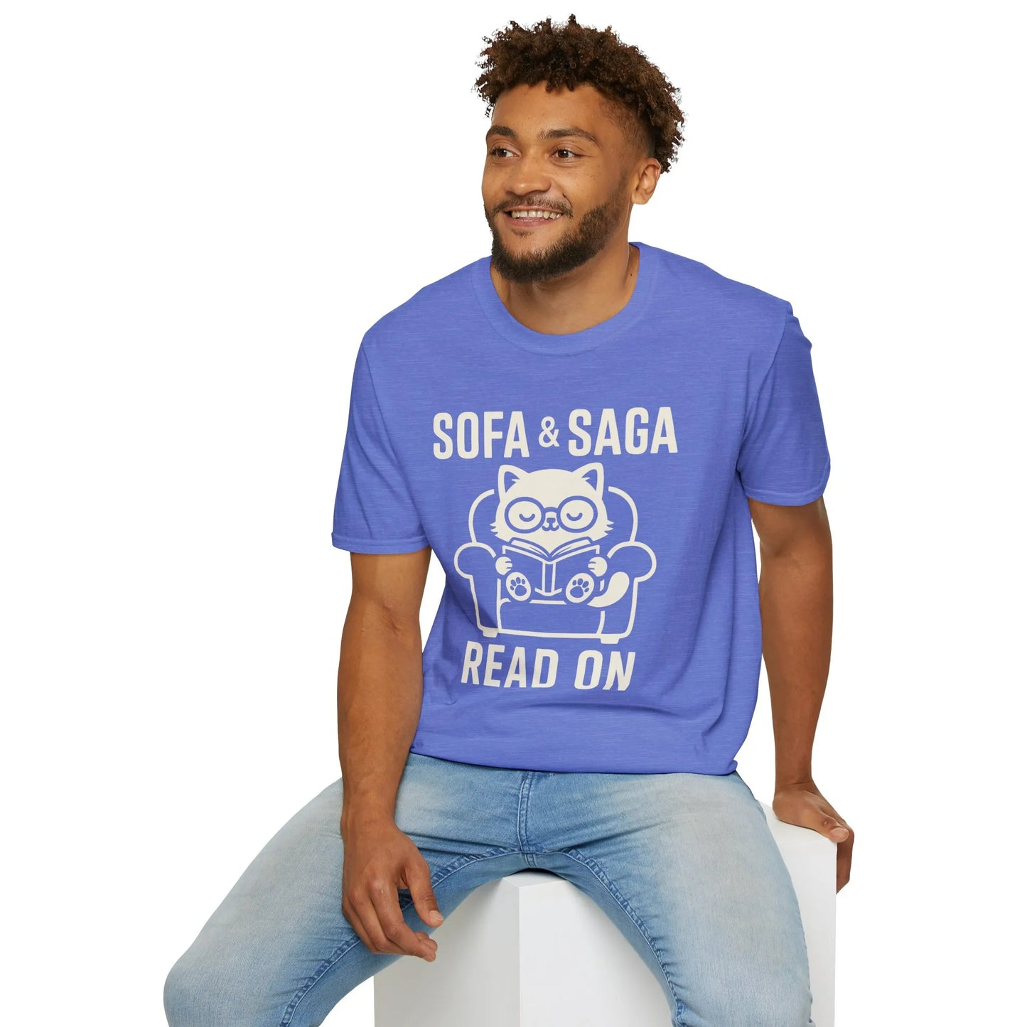 Cozy blue Sofa & Saga tee featuring a cat reading on a chair, perfect for book lovers and witty readers.