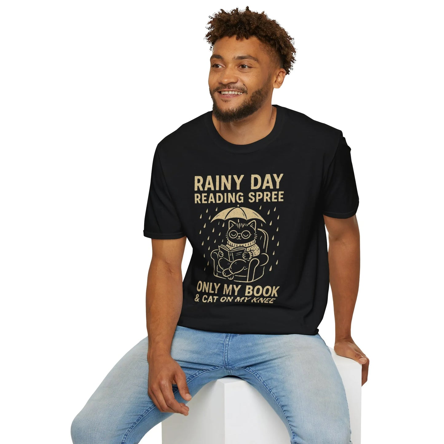 Cozy Rainy Day Reading Spree tee with a cat under an umbrella, perfect gift for book lovers and cat enthusiasts.