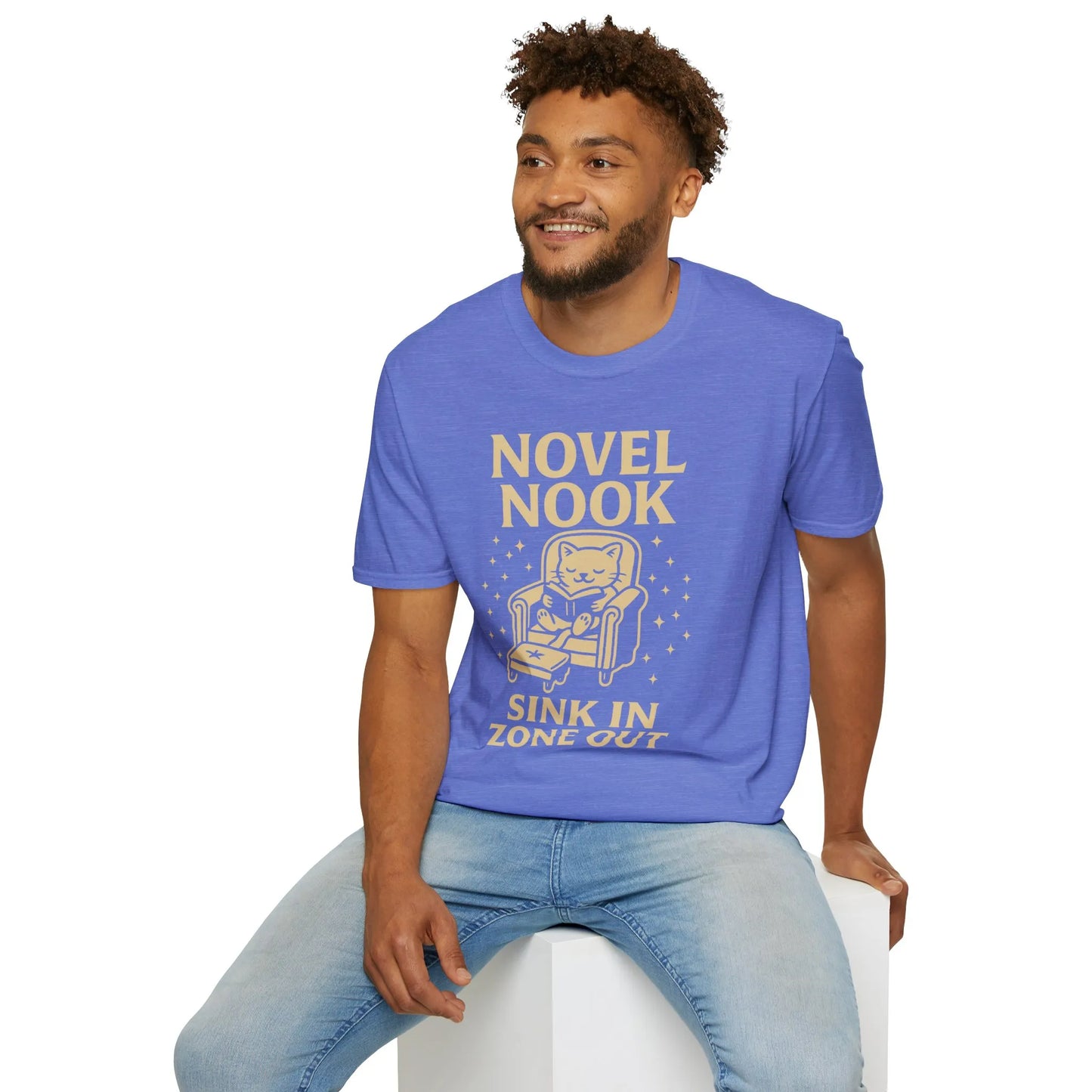Cozy Novel Nook T-Shirt for book lovers, featuring a cat in an armchair with 'Sink In Zone Out' text. Perfect gift for readers!