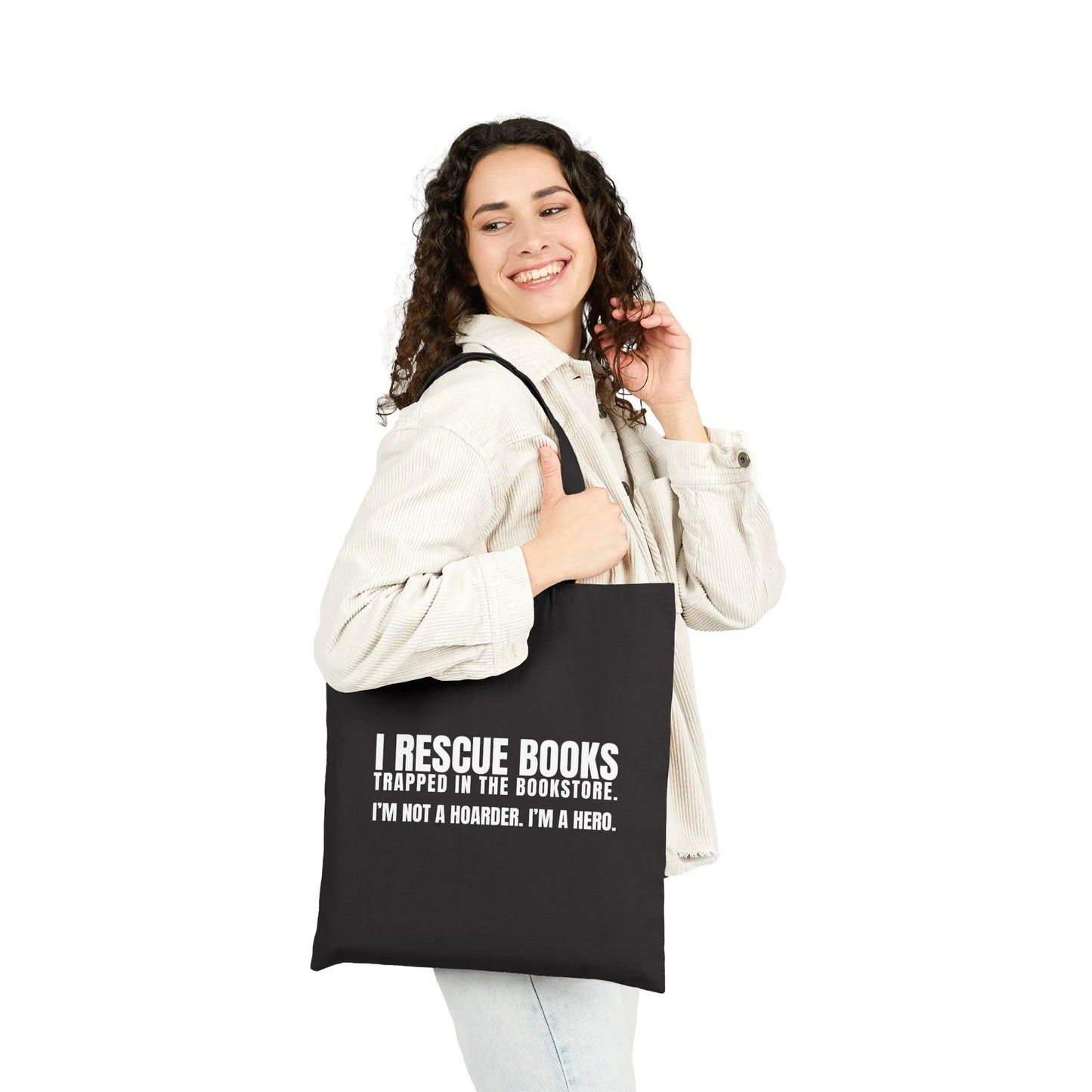 A smiling woman holds an eco-friendly tote bag reading 'I Rescue Books'—a perfect gift for book lovers and bibliophiles.