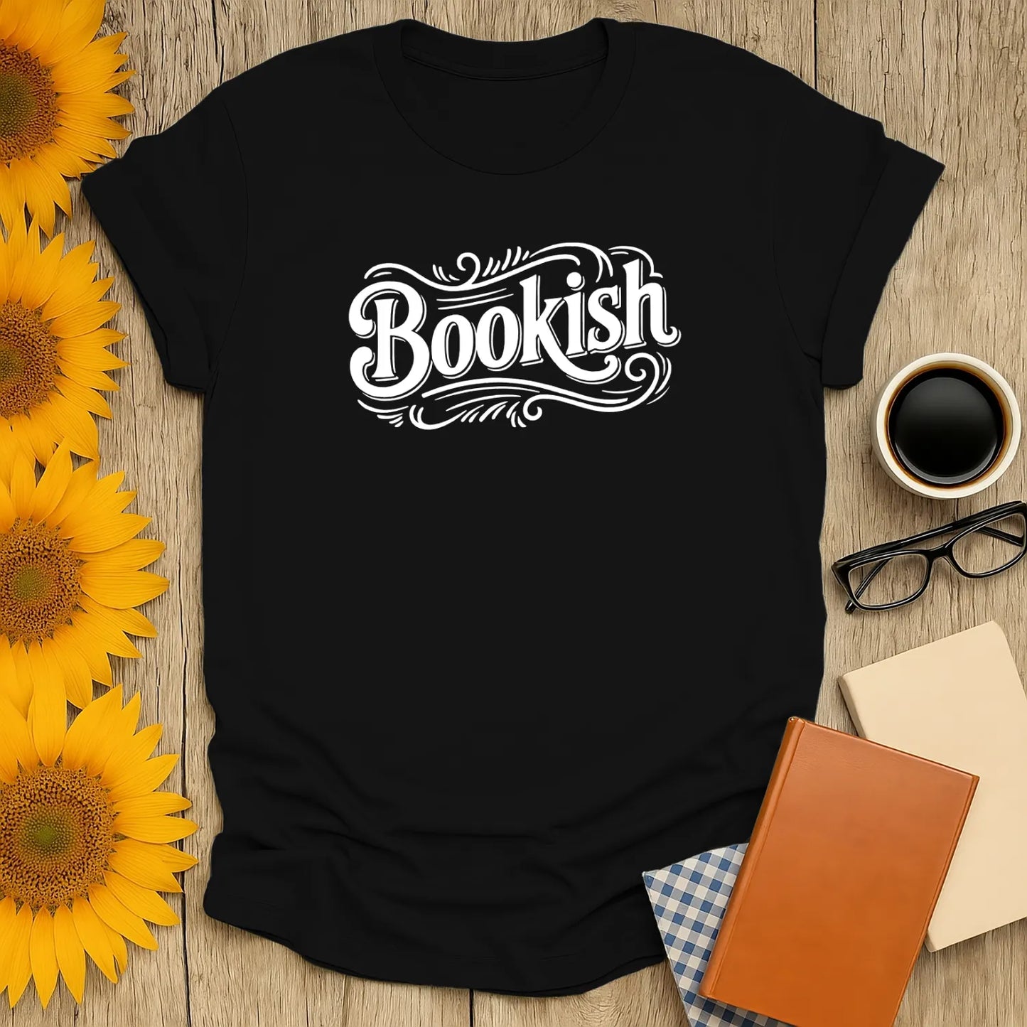 Classic black 'Bookish' T-shirt perfect for cozy readers, surrounded by books, coffee, and sunflowers – a delightful gift for book lovers!
