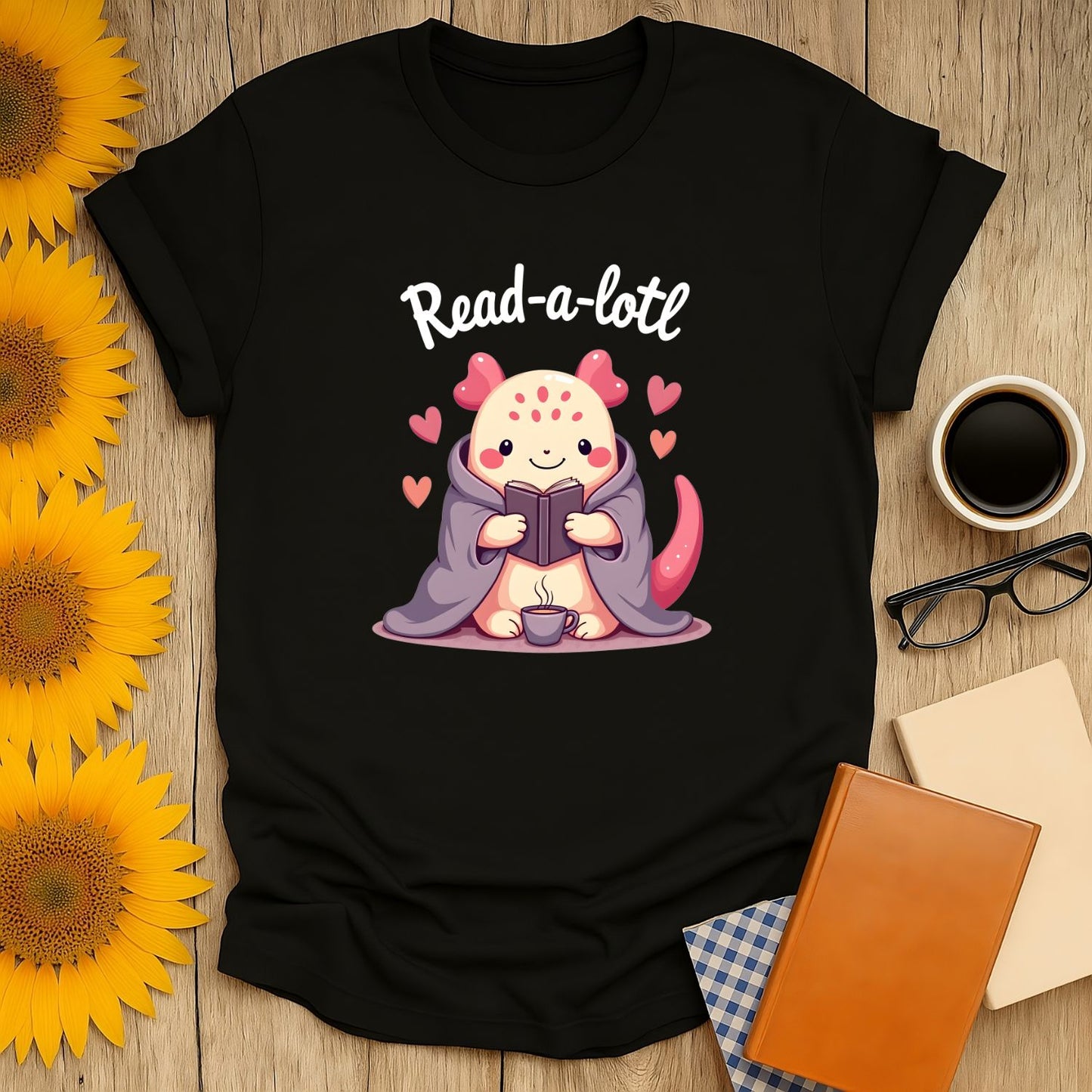 Cozy Read-a-lotl shirt featuring a cute creature reading with hearts, perfect for book lovers who adore cats and coffee.