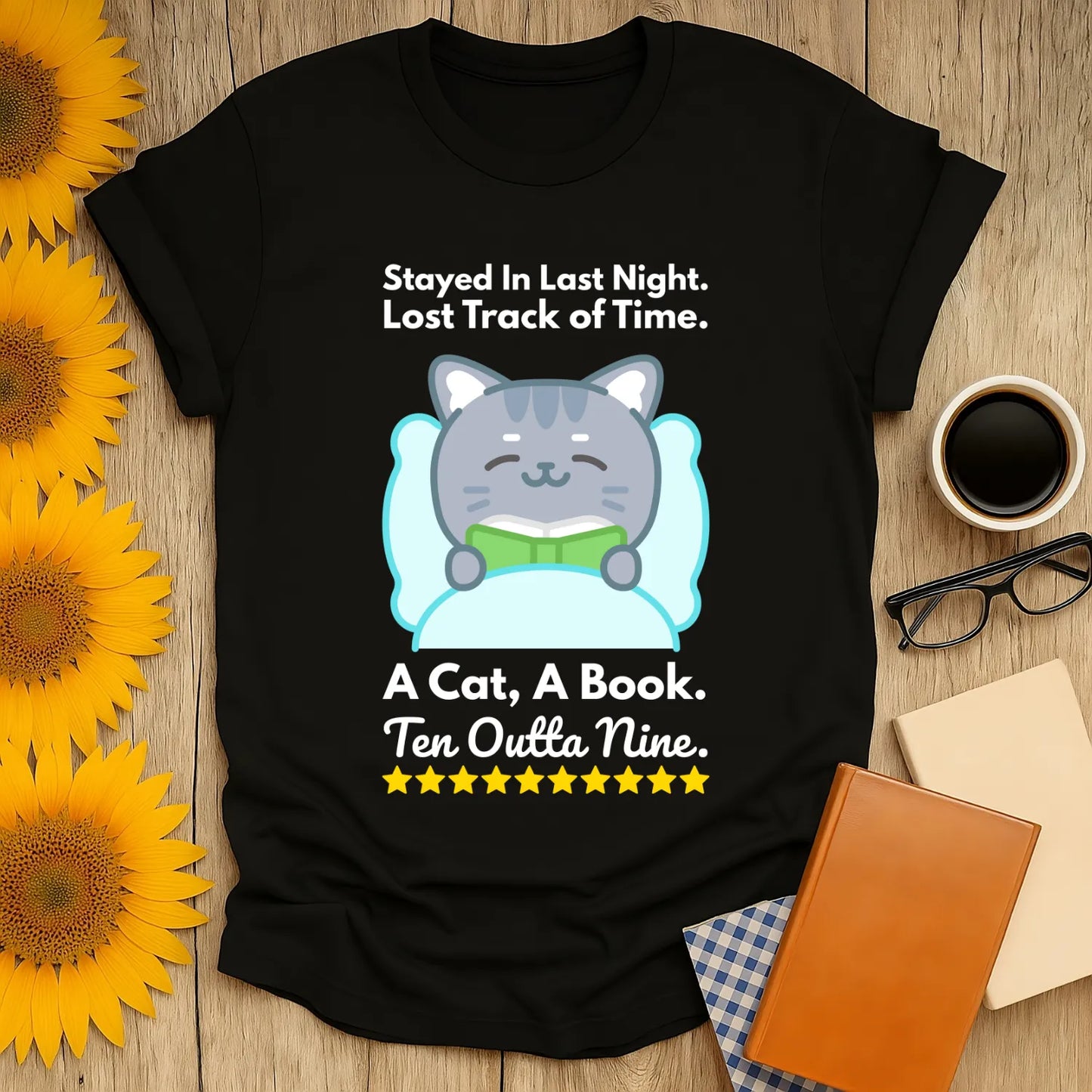 Cozy black t-shirt featuring a cute cat reading, with text: "A Cat, A Book. Ten Outta Nine." Perfect for book lovers and cat fans!