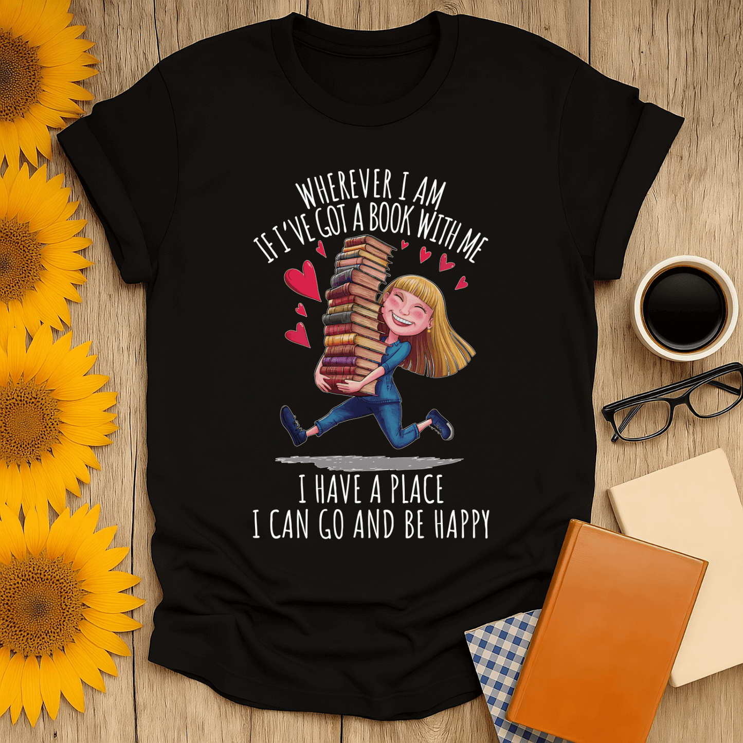 Black t-shirt with book lover design featuring girl holding stacked books with text 'Wherever I am, I have a place to be happy'.