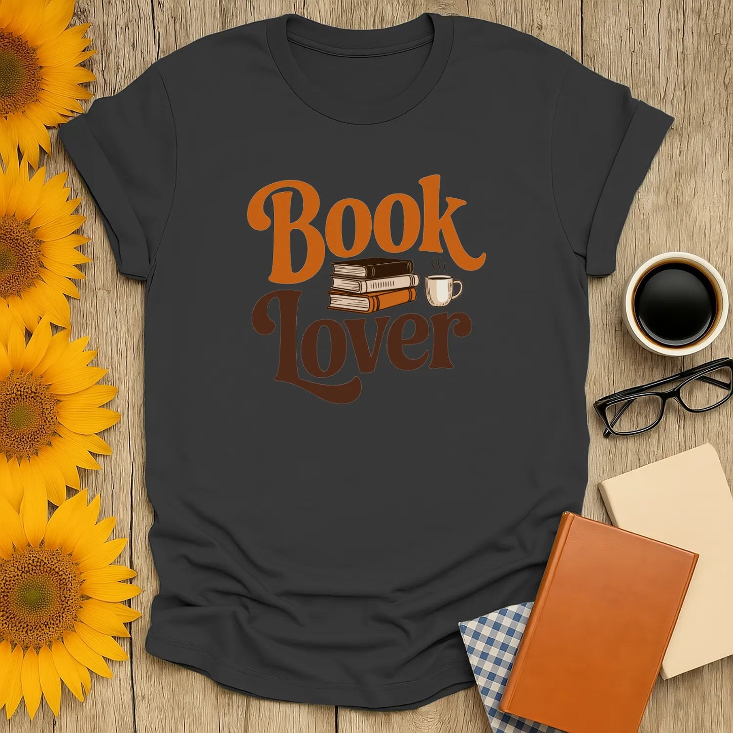 Cozy book lover shirt featuring stacked books and a steaming coffee cup, perfect for tea and cat enthusiasts.