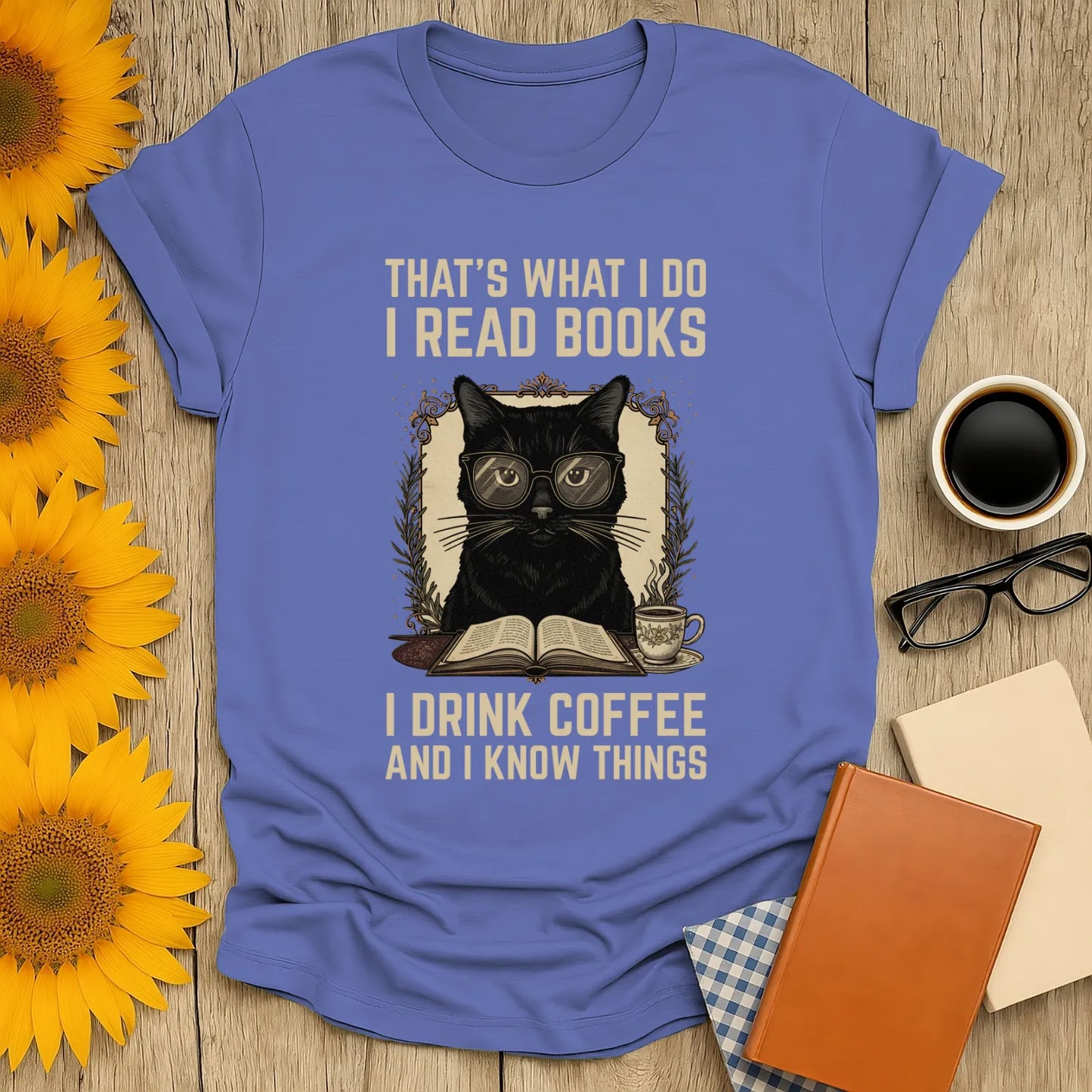 Coffee Cat Reader T-Shirt featuring a black cat in glasses with a coffee and book, humorously stating 'I read books, I drink coffee and I know things'.