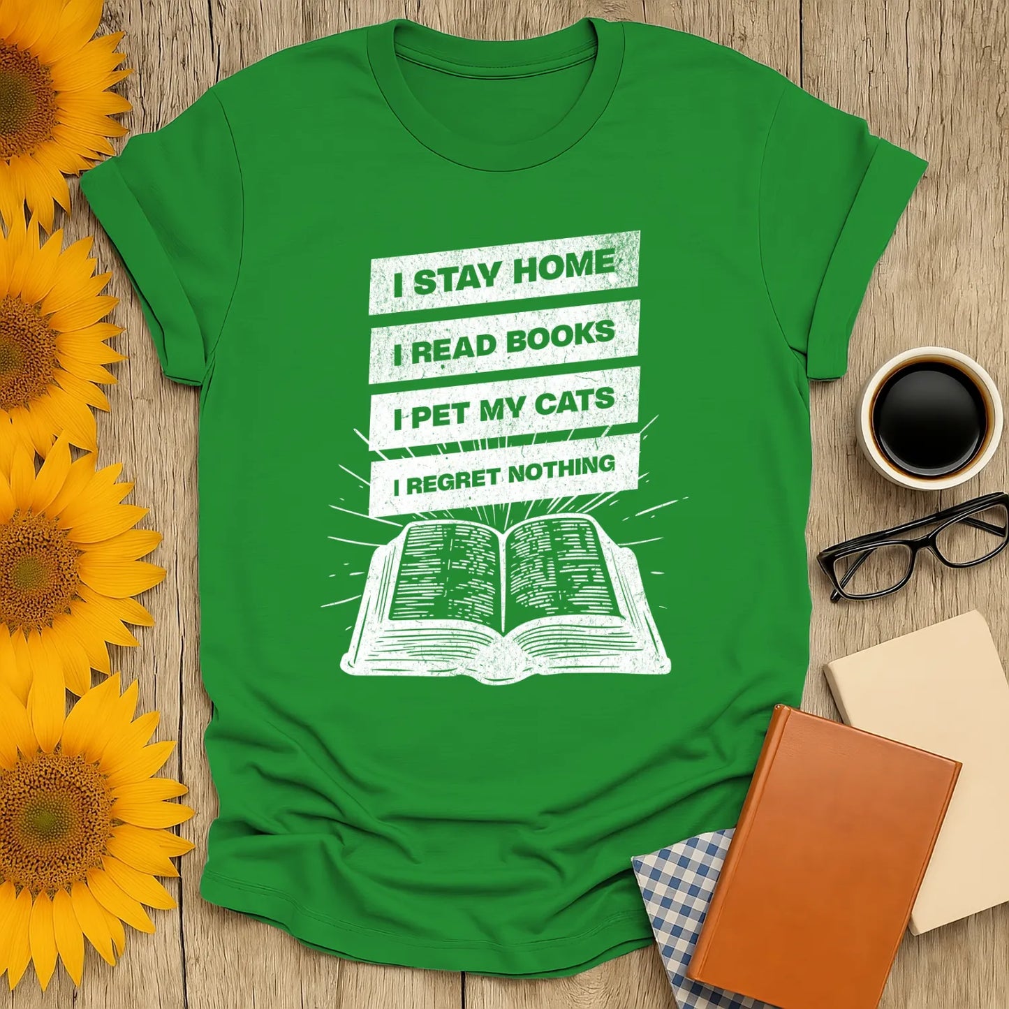 Stay Home Reader T-Shirt featuring a green tee with bold text: "I STAY HOME, I READ BOOKS, I PET MY CATS, I REGRET NOTHING" over a book illustration. Perfect gift for cozy book lovers!