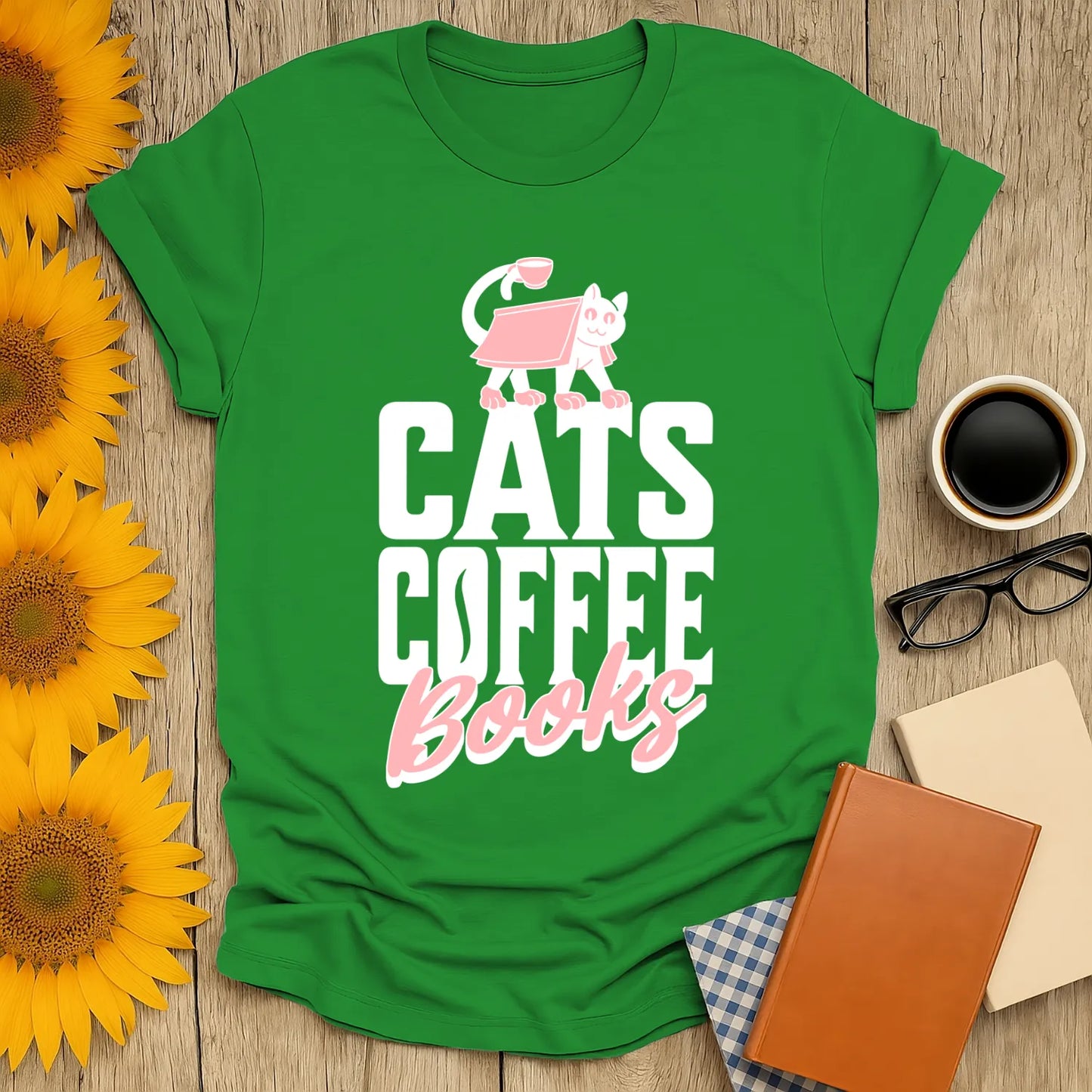 A playful green t-shirt featuring the text 'CATS COFFEE Books' with a cute cat illustration, perfect for book lovers.