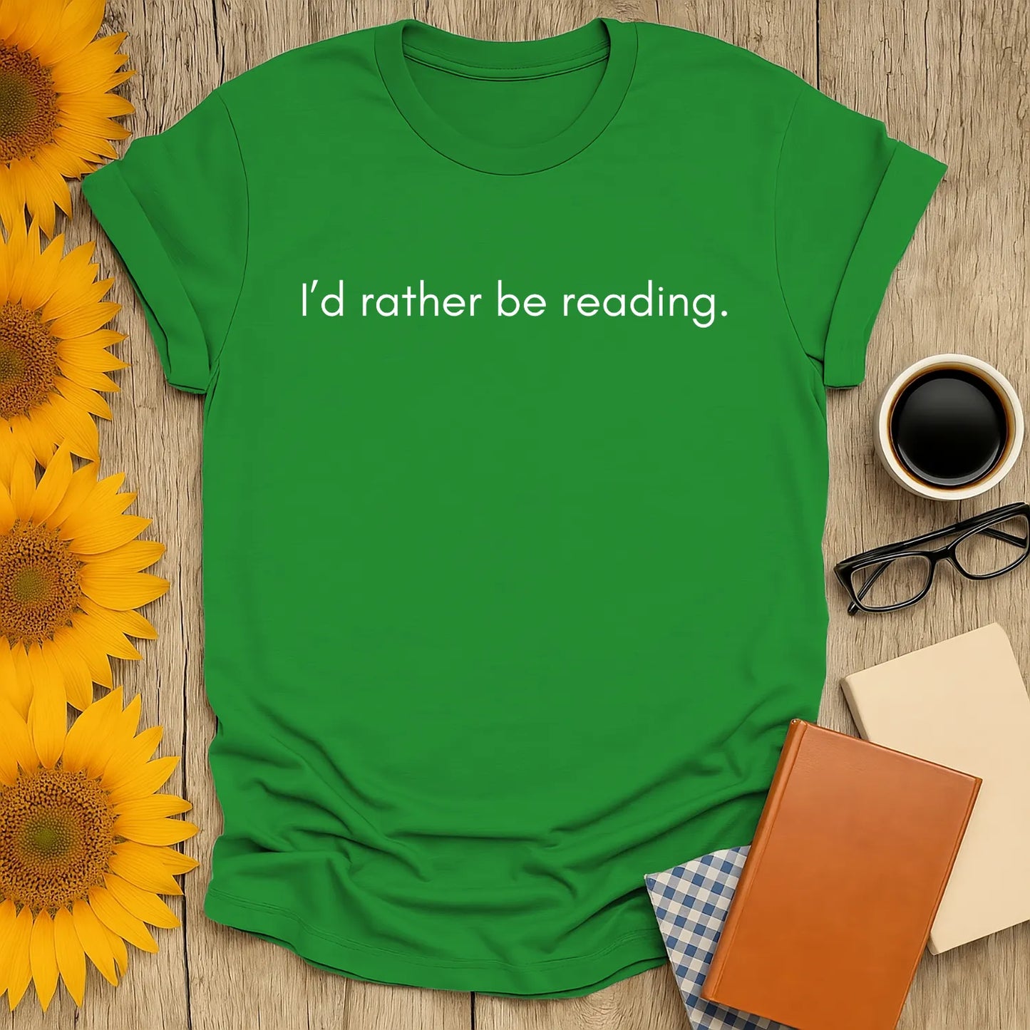 Green t-shirt with the text 'I’d rather be reading.' Perfect book lover shirt for cozy moments with coffee or tea.