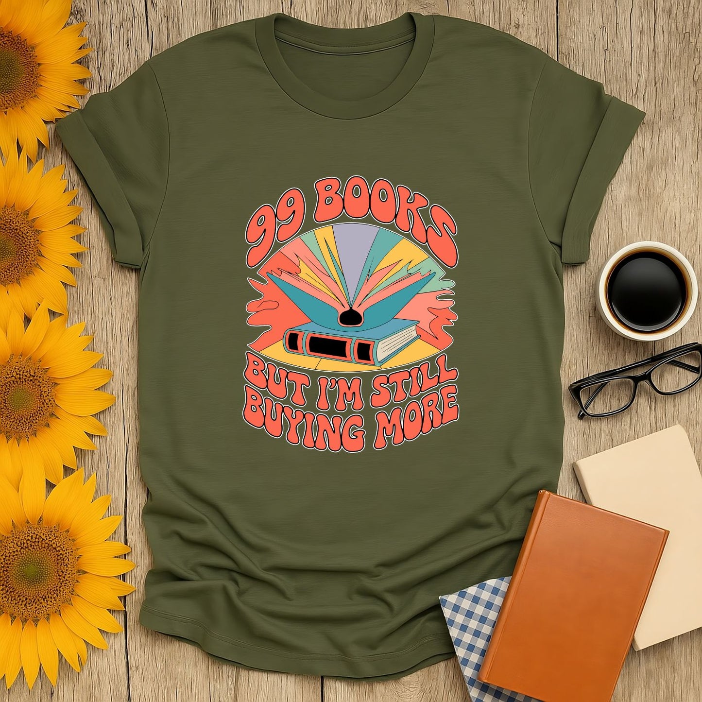 99 Books T-Shirt featuring colorful design and text "But I'm Still Buying More" - a cozy shirt for book lovers!