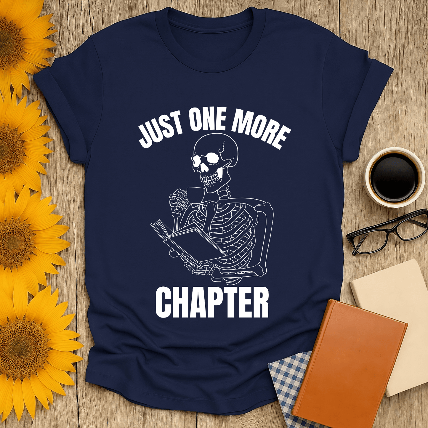 Skeleton Reader T-Shirt for book lovers, featuring a design that says 'Just One More Chapter' on a navy background.