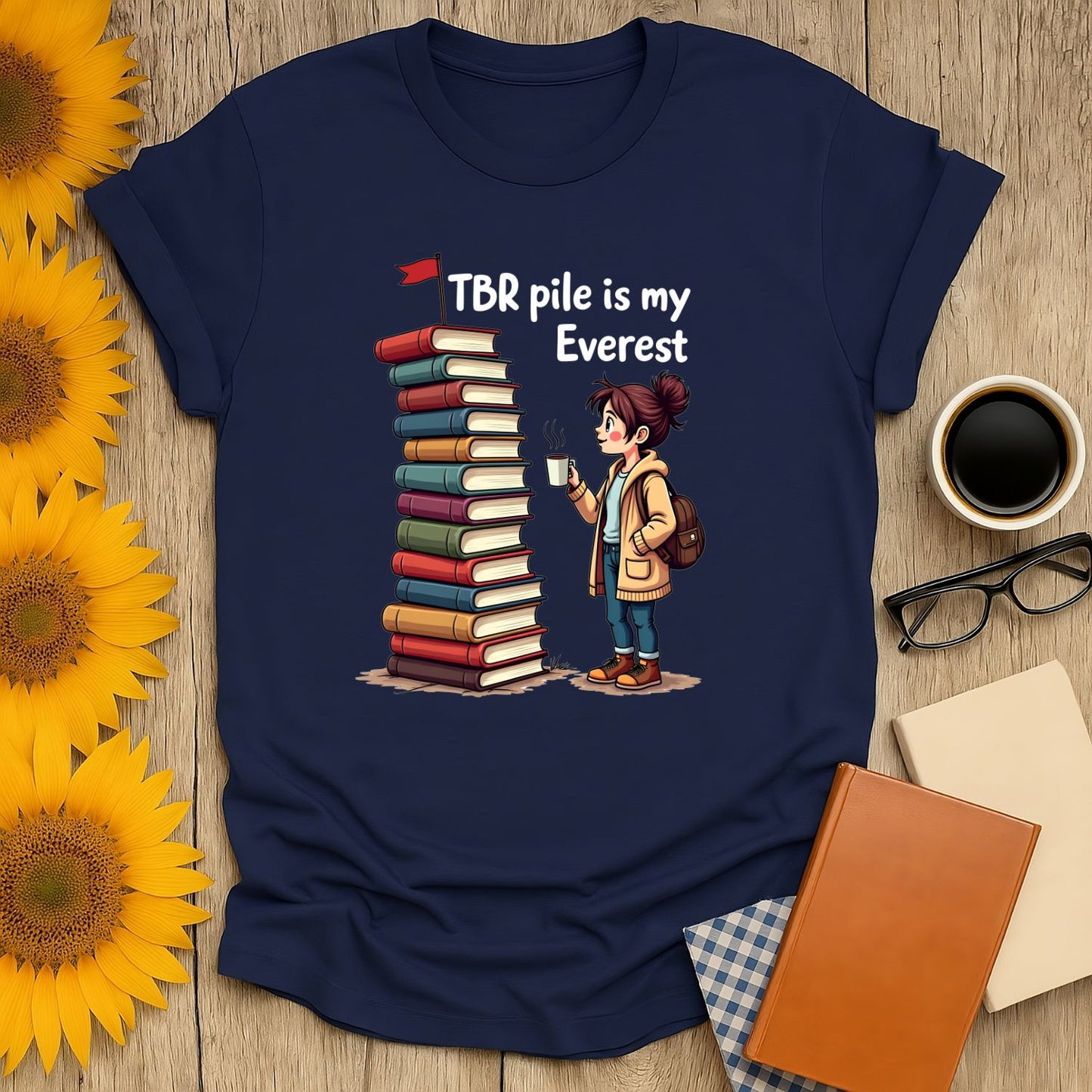 Bookish Everest T-Shirt featuring a girl holding coffee beside a towering stack of books with the text 'TBR pile is my Everest'.