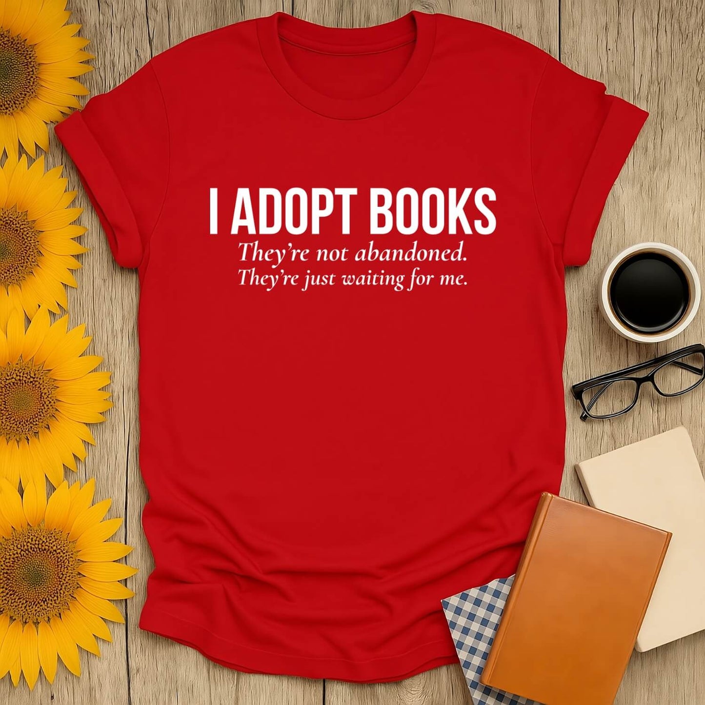 Red book lover t-shirt with text 'I Adopt Books' and floral decor, perfect for reading enthusiasts.