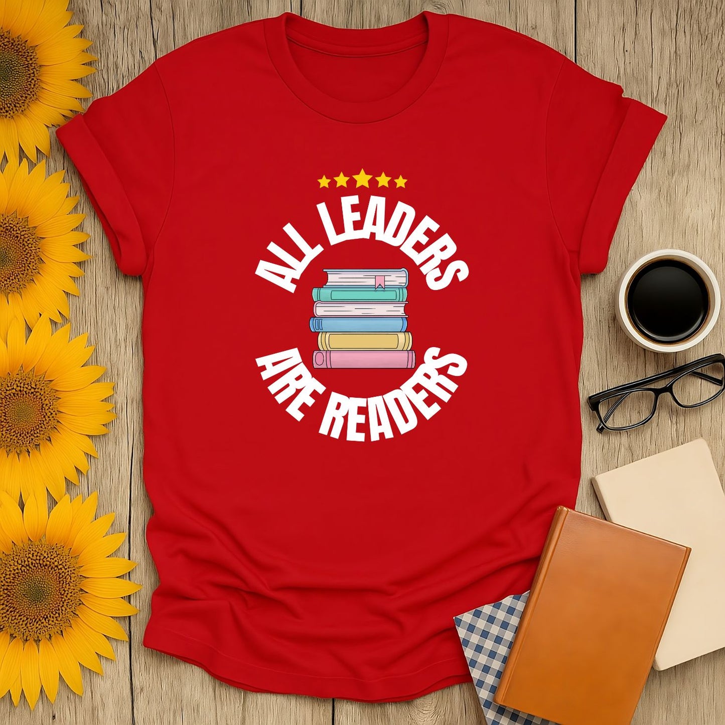 Bright red t-shirt with 'All Leaders Are Readers' text and a stack of colorful books, perfect for book lovers!