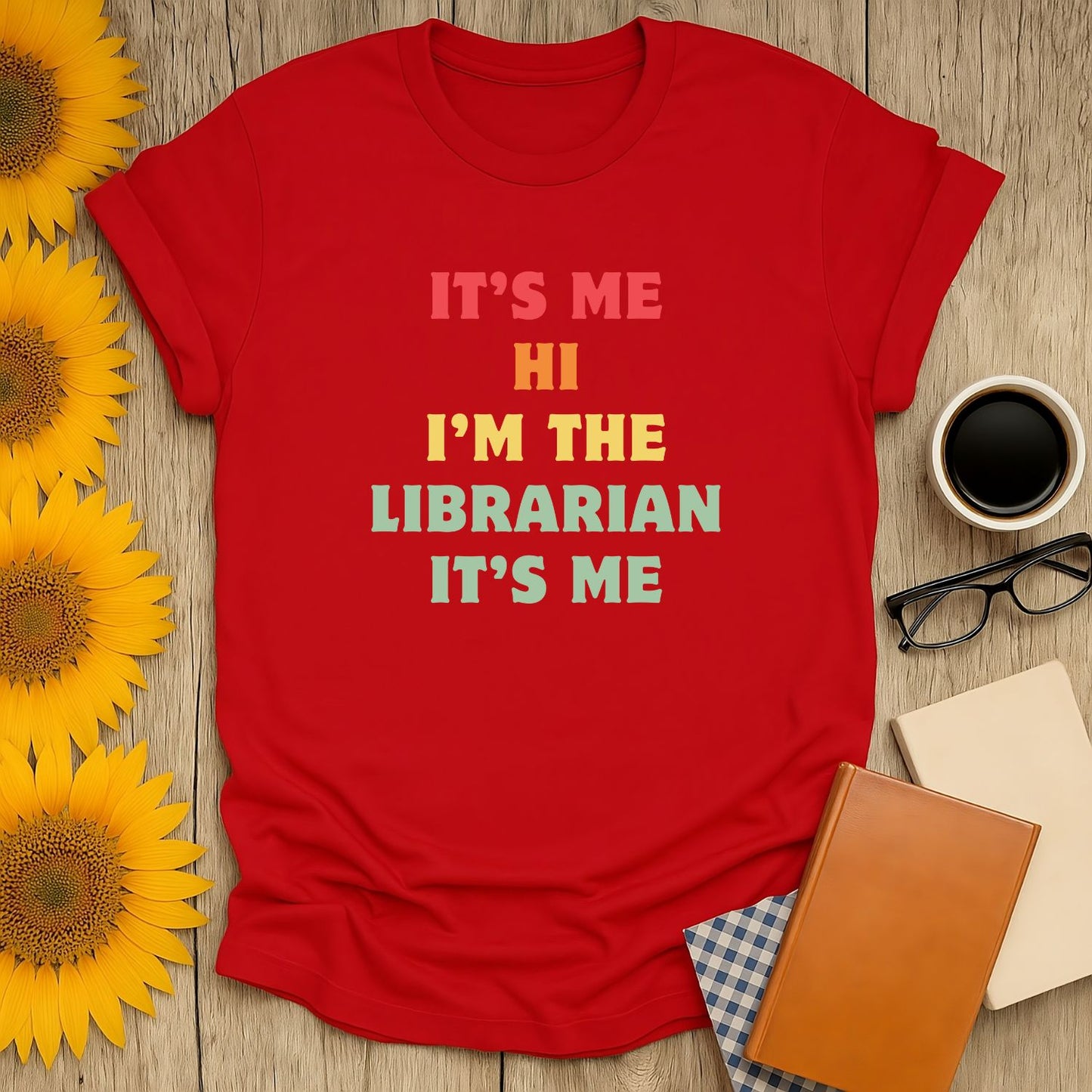 Red librarian t-shirt with playful text: "IT'S ME HI I'M THE LIBRARIAN IT'S ME". Perfect cozy shirt for book lovers!