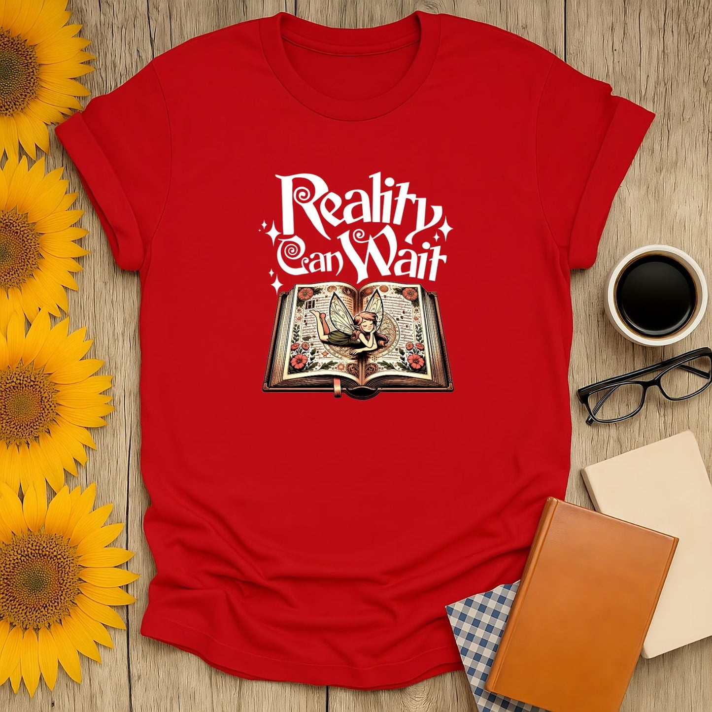 Reality Can Wait T-Shirt featuring a whimsical open book, perfect for book lovers, cat enthusiasts, and cozy readers.