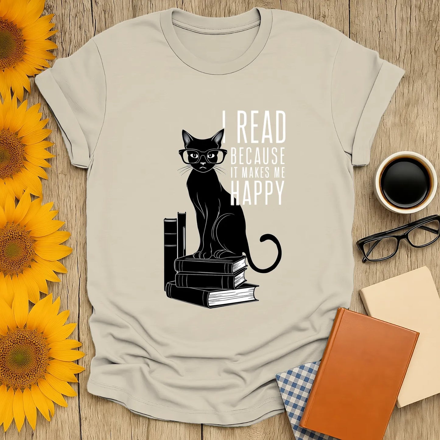 Funny reading tee featuring a black cat with glasses on stacked books with the text: 'I read because it makes me happy'.