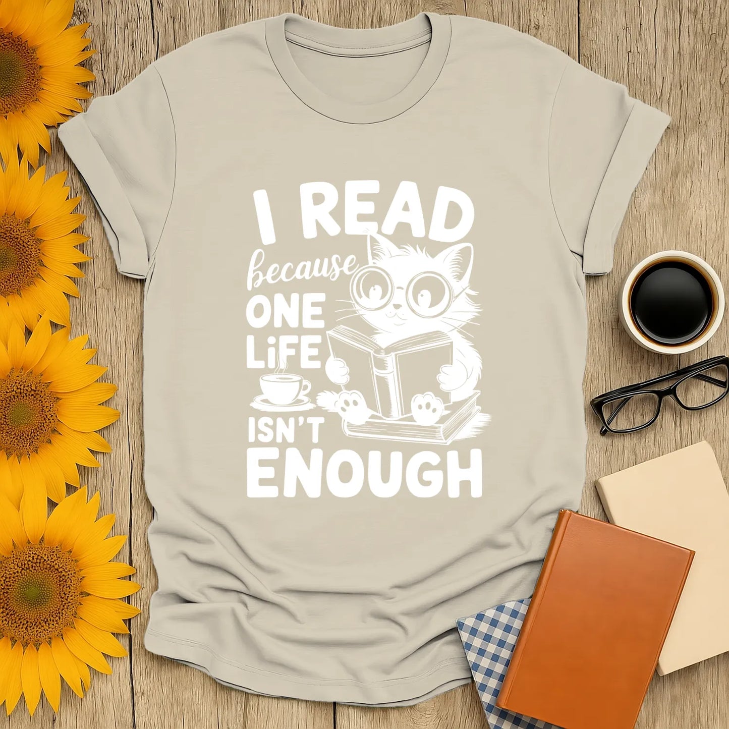Cozy t-shirt with a cute cat reading and text "I read because one life isn’t enough" Perfect for book lovers and cat fans.