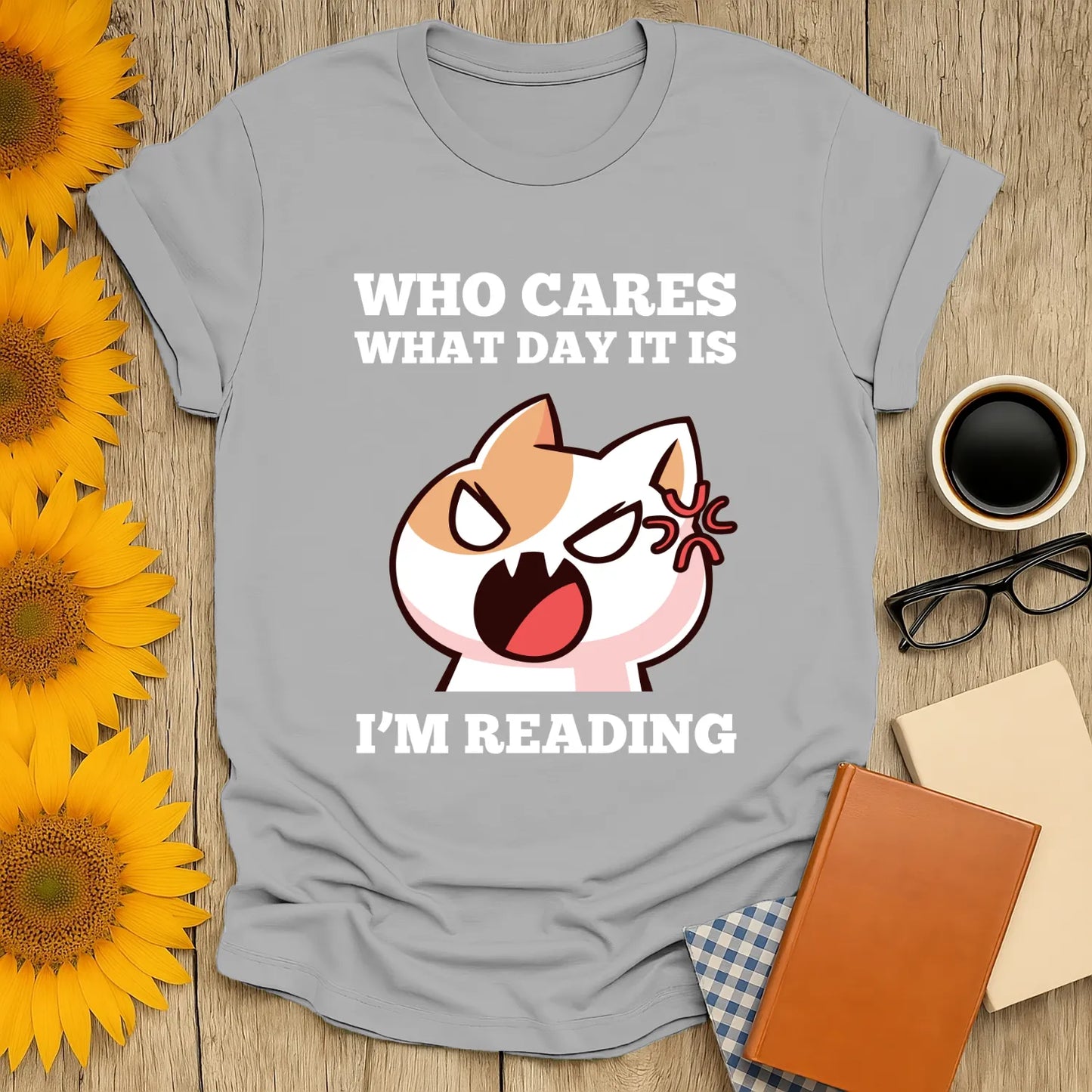 Funny cat graphic tee with text 'Who cares what day it is, I’m reading'—perfect gift for book lovers and cat enthusiasts.