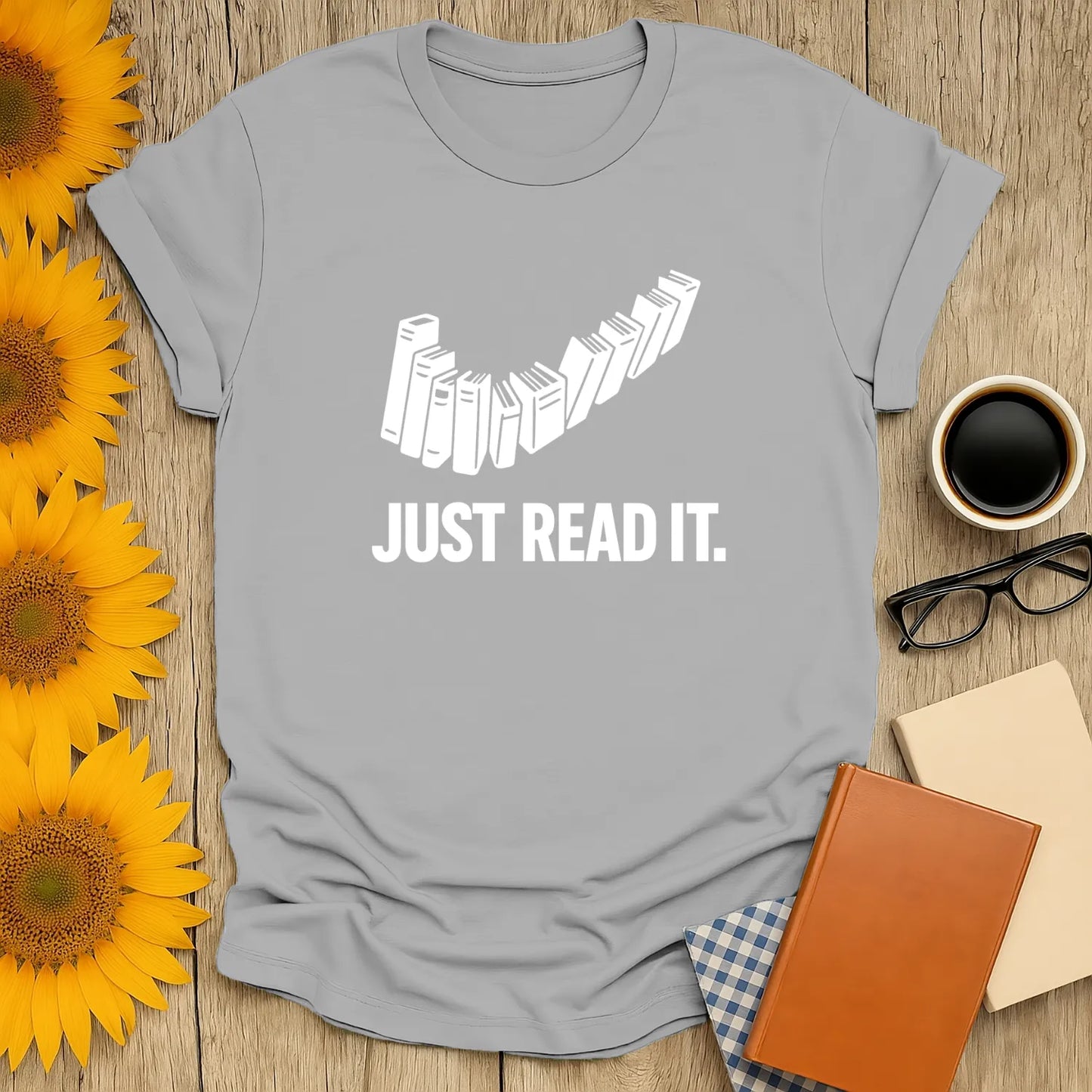 Gray Just Read It t-shirt with stacked books illustration, perfect cozy shirt for book lovers enjoying tea or coffee.