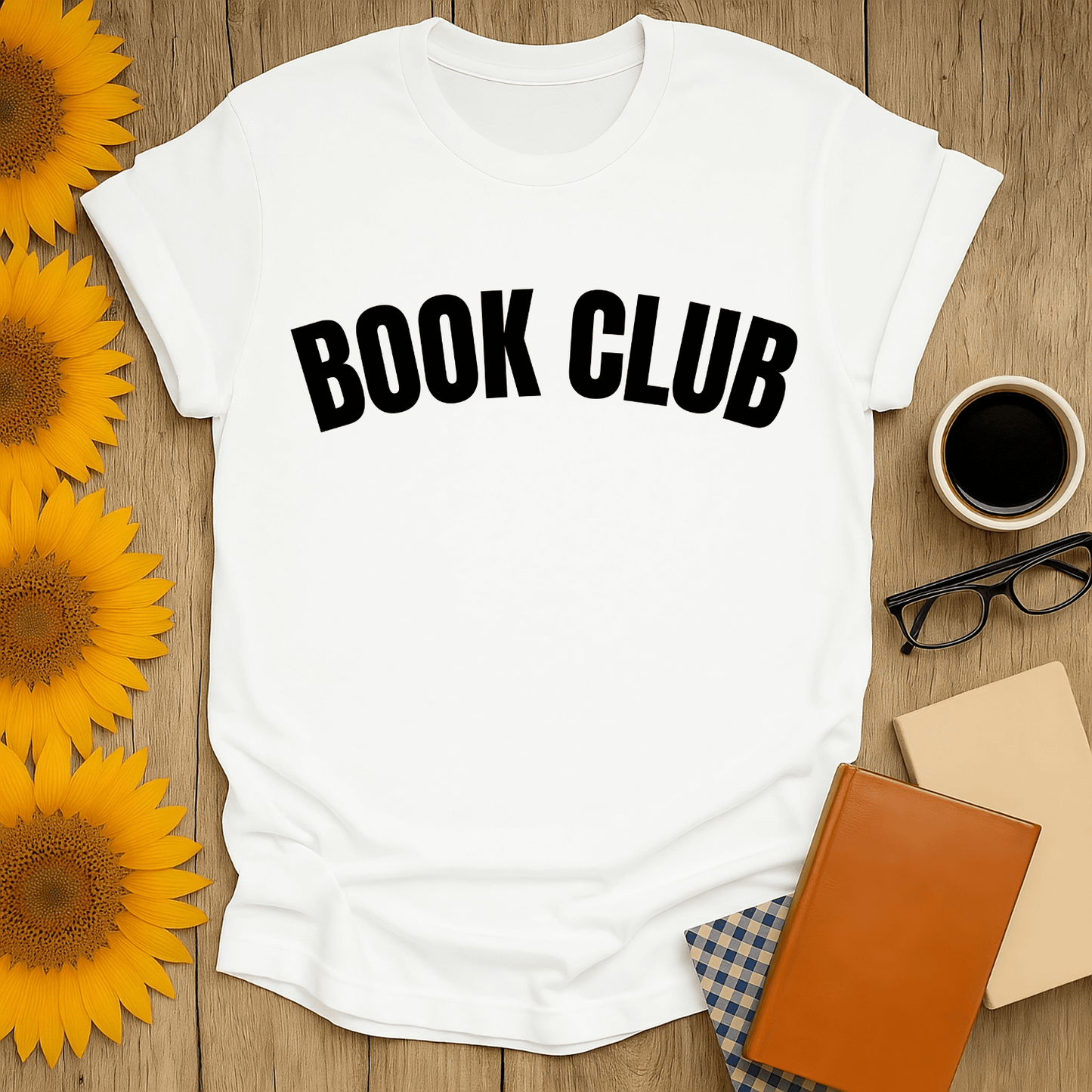 Book lover t-shirt featuring 'BOOK CLUB' design on a white, unisex shirt with a cozy setup of books and sunflowers.