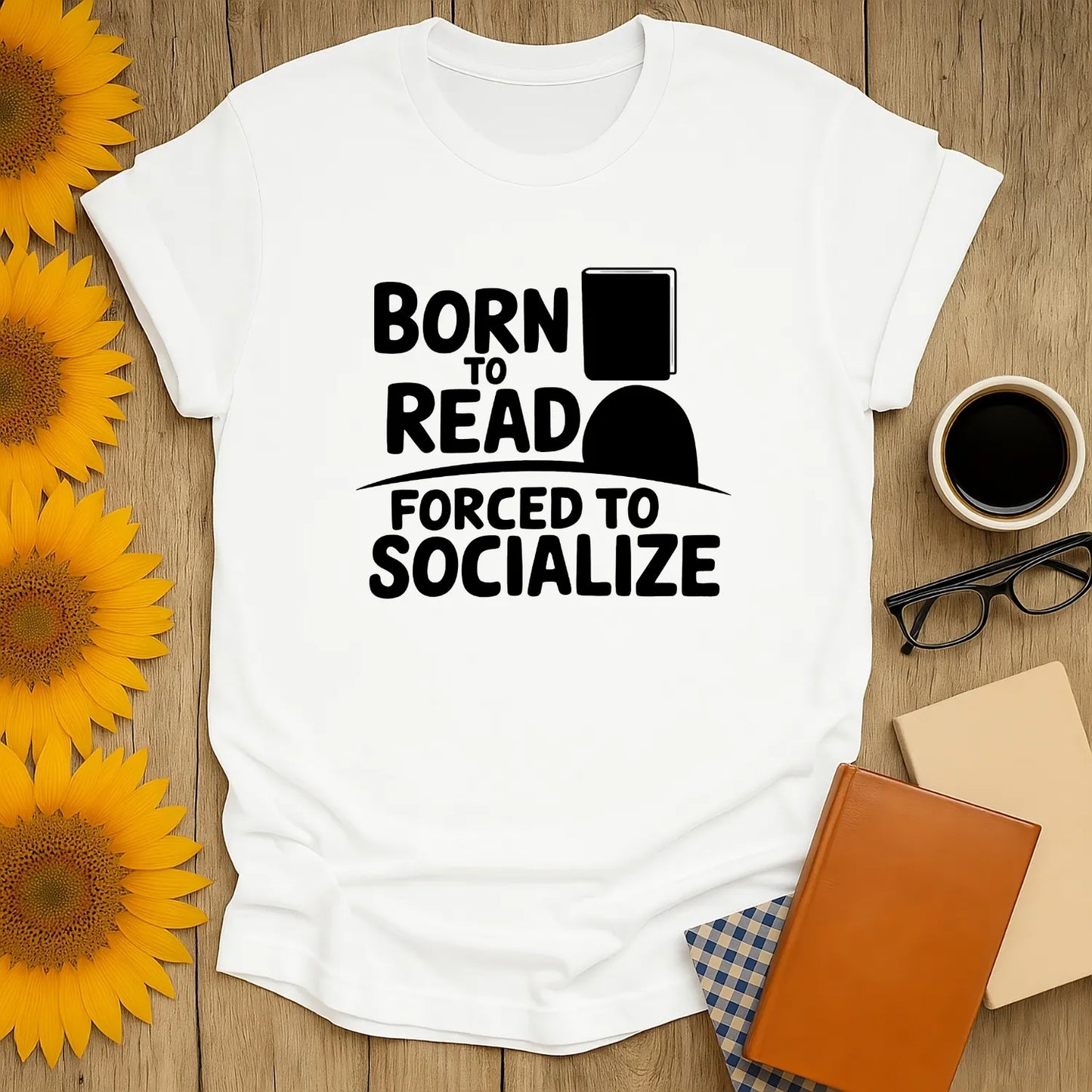 Funny book lover shirt featuring "Born to Read, Forced to Socialize" text. Perfect gift for cozy readers and cat, coffee, or tea enthusiasts.