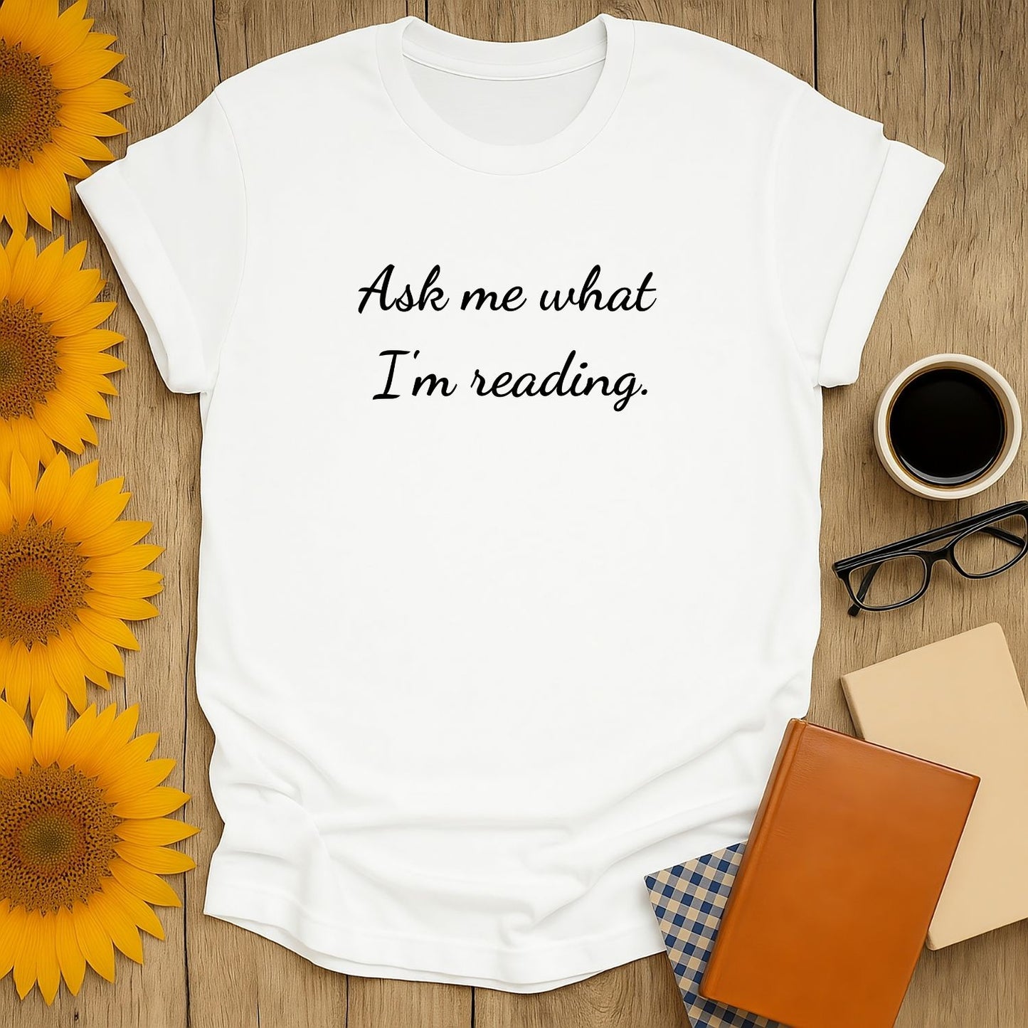 Cozy book lover shirt featuring 'Ask me what I'm reading.' Perfect for readers who adore cats, coffee, and bookish humor.
