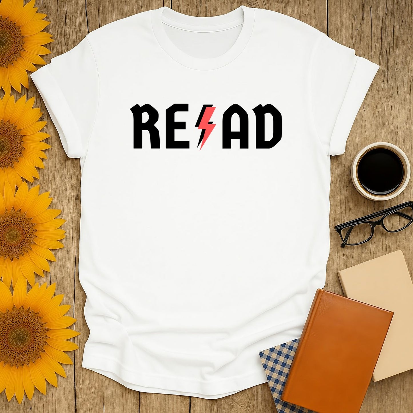 Cozy white t-shirt with 'READ' in bold letters and a lightning bolt, perfect gift for book lovers and cat enthusiasts.