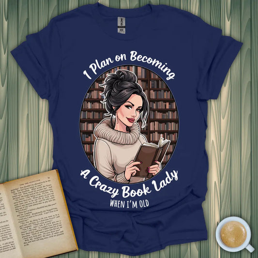 Navy blue t-shirt featuring a woman reading, saying 'I Plan on Becoming A Crazy Book Lady When I'm Old' - perfect for book lovers.