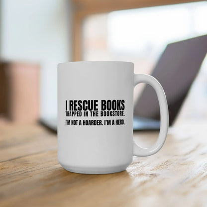 I Rescue Books Mug featuring bold text: "I RESCUE BOOKS TRAPPED IN THE BOOKSTORE. I'M NOT A HOARDER. I'M A HERO." Perfect for book lovers!