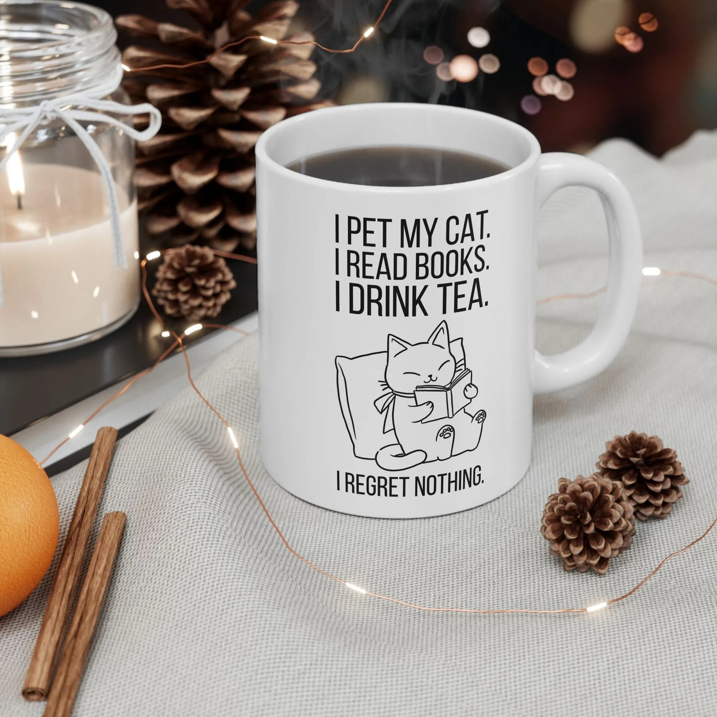 Purrfect Tea & Tales Mug with a reading cat illustration and the text: 'I pet my cat. I read books. I drink tea. I regret nothing.'