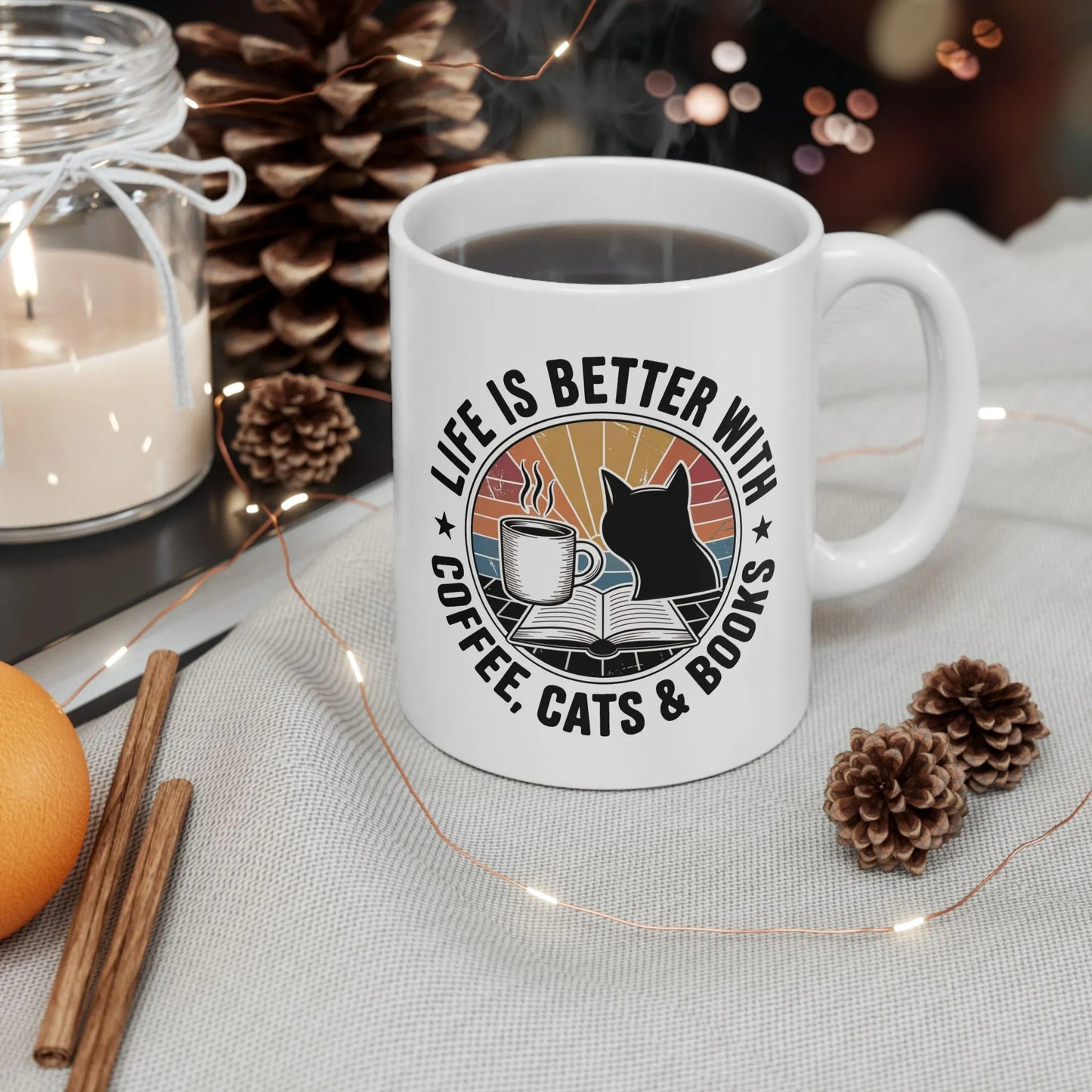 Sunset Reads & Whiskers Mug featuring text 'Life is better with coffee, cats & books' in vibrant colors, perfect for book lovers.