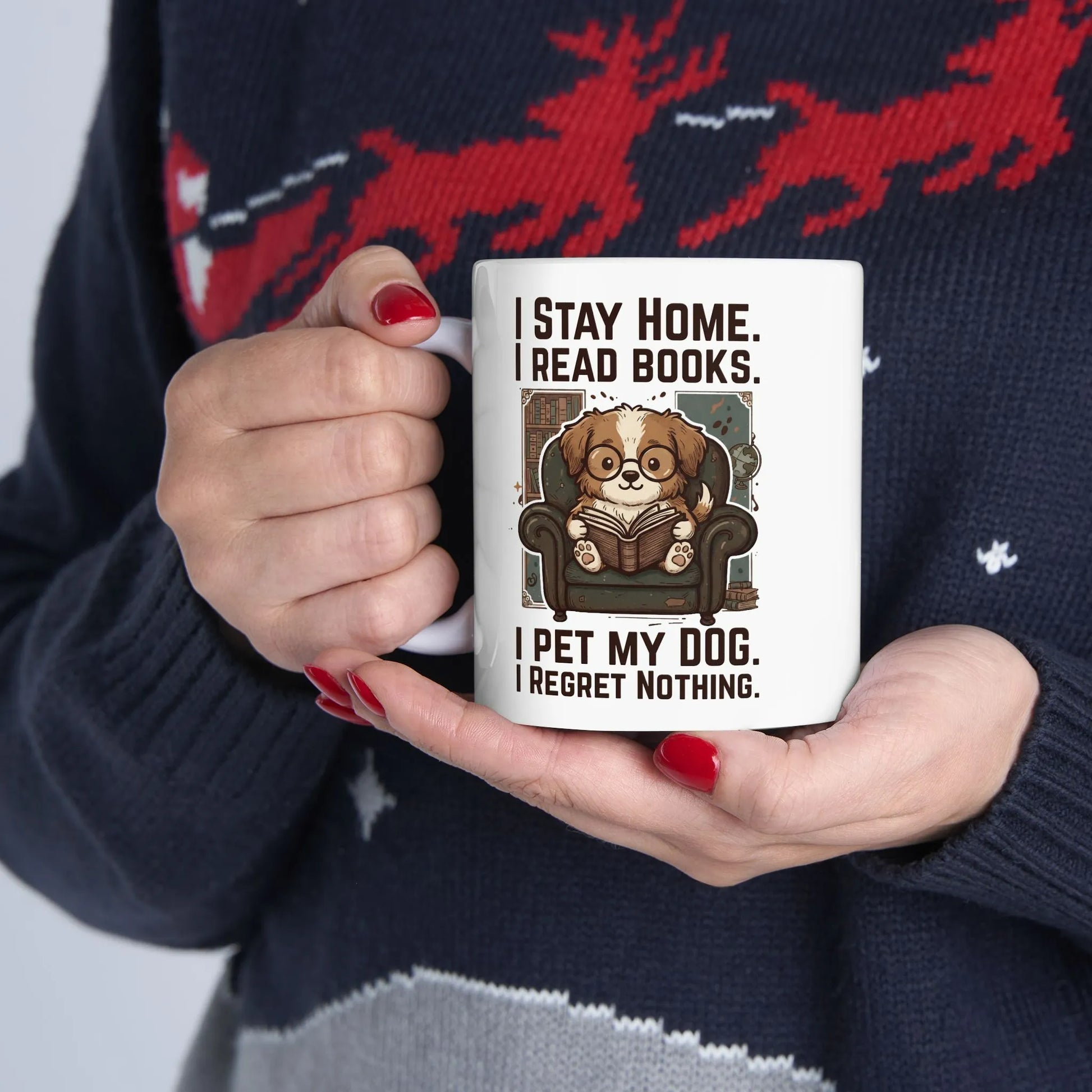 Library Dog Reader Mug held by a person, featuring a cute dog reading a book with a cozy, humorous design perfect for book lovers.