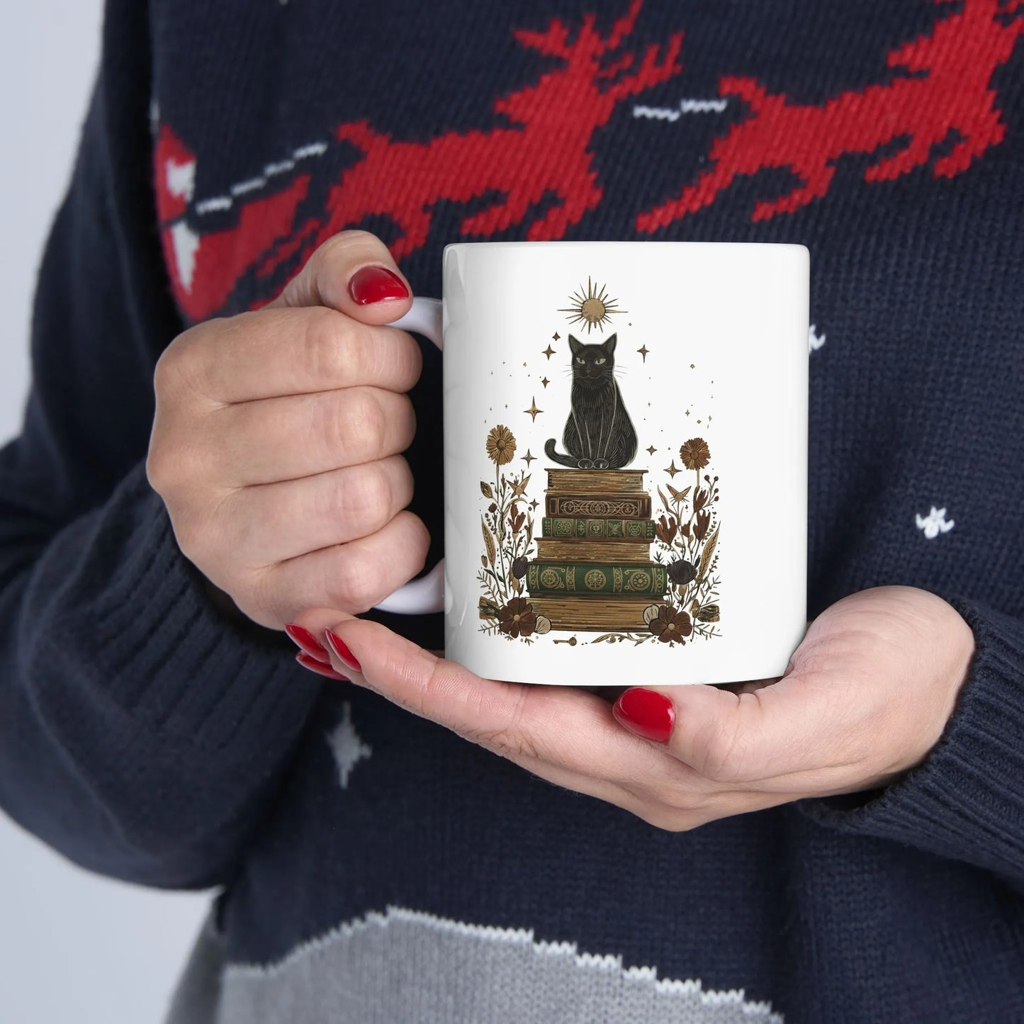 Mystic Cat & Books Mug featuring a black cat on vintage books with celestial details, ideal for cozy reading moments.