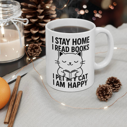 Happy Cat Reader Mug with a cute cat illustration and text: I stay home, I read books, I pet my cat, I am happy.