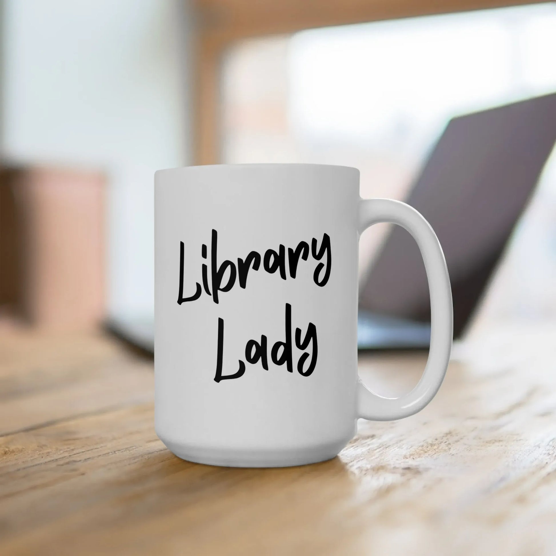 Library Lady Mug featuring bold handwritten text on a white ceramic cup, perfect for book lovers and cozy reading moments.