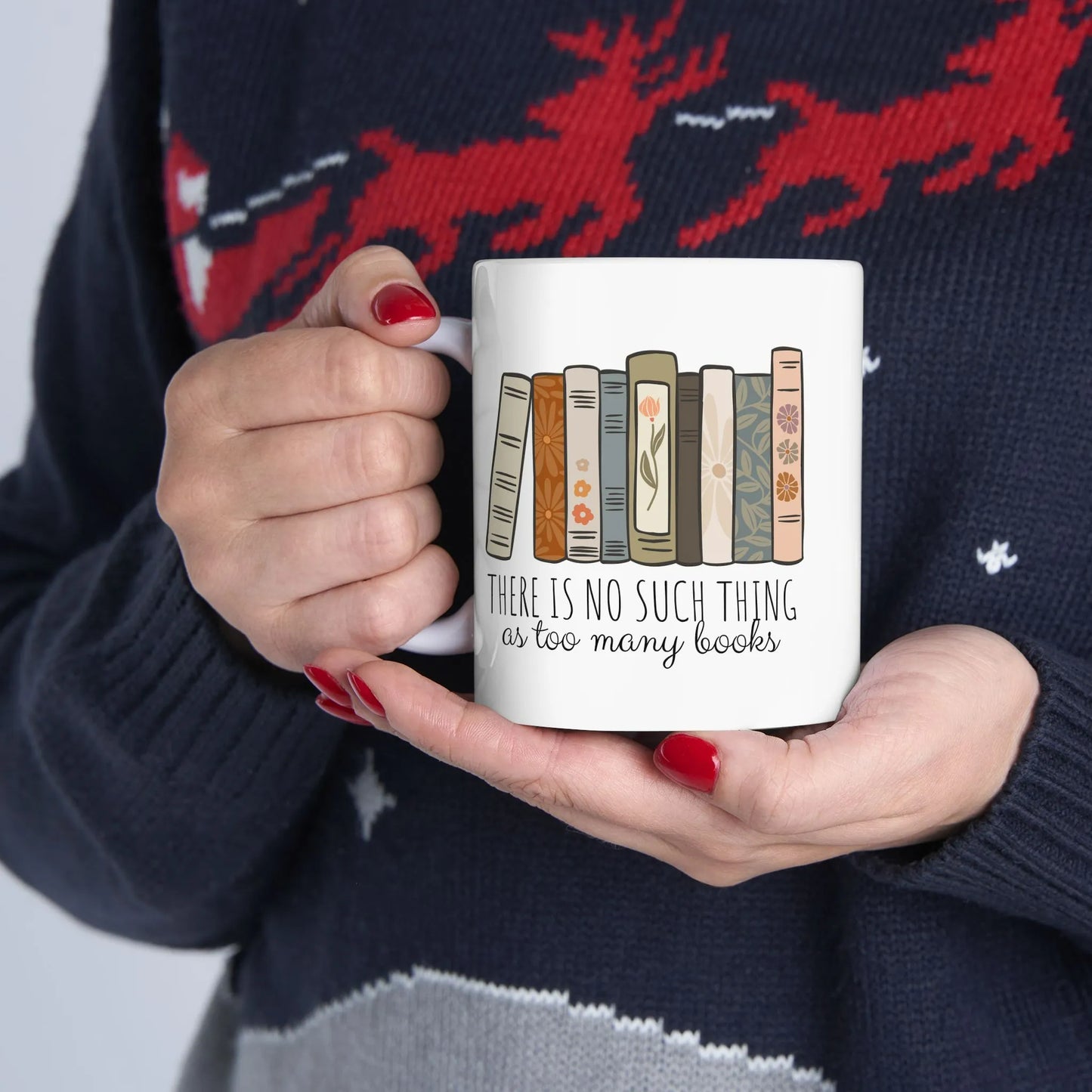 Too Many Books Mug featuring colorful book illustrations and the phrase 'There is no such thing as too many books' for book lovers.