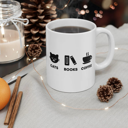 Holy Trinity Mug featuring cute icons: cats, books, and coffee, perfect for cozy reading sessions and gifts for readers.