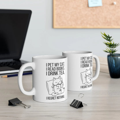 Purrfect Tea & Tales Mug with a cute kitty and text: 'I pet my cat. I read books. I drink tea. I regret nothing.' Perfect for cozy reading!