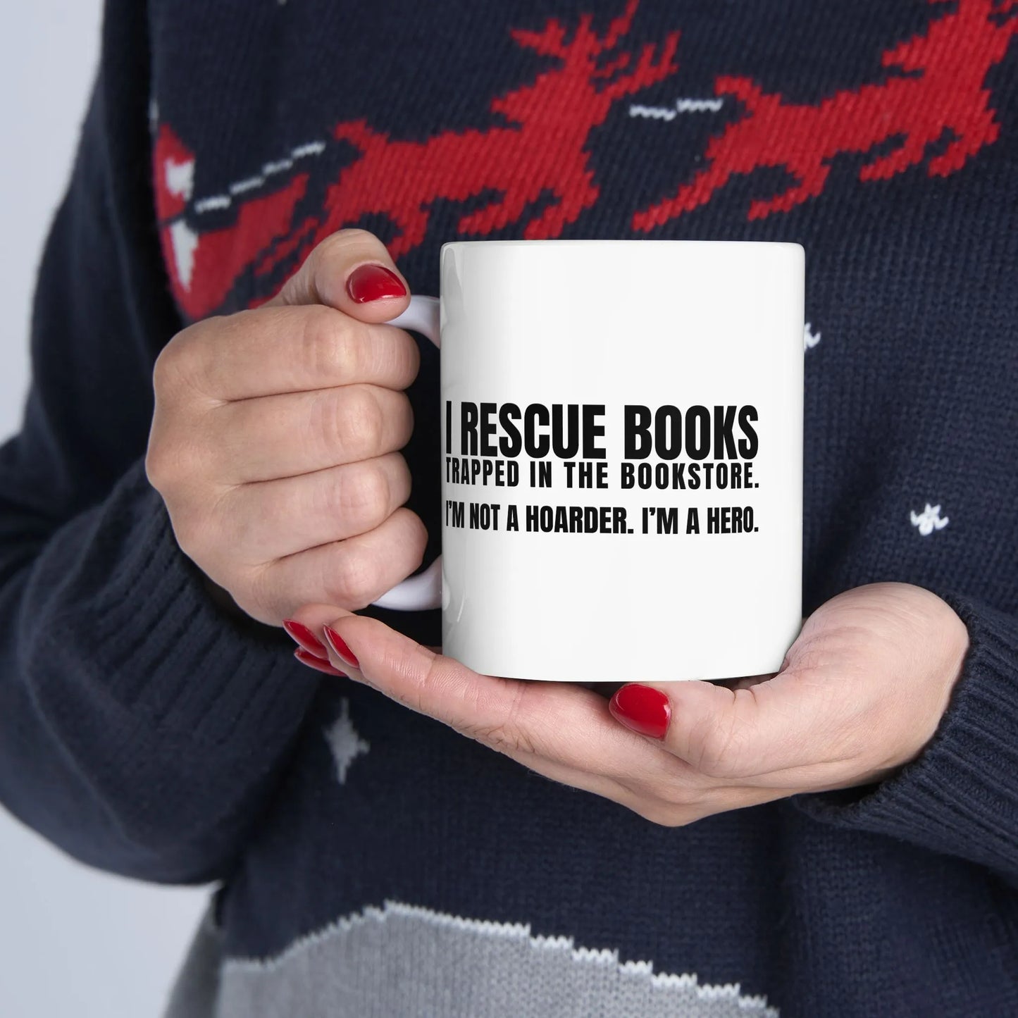 I Rescue Books Mug featuring humorous text: "IRESCUE BOOKS TRAPPED IN THE BOOKSTORE. I’M NOT A HOARDER. I’M A HERO." Perfect gift for book lovers, coffee fans.