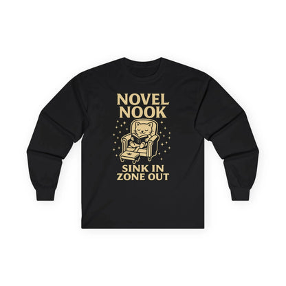 Novel Nook Long Sleeve shirt with cat in armchair, text 'Sink In Zone Out', perfect for book lovers and cozy moments.