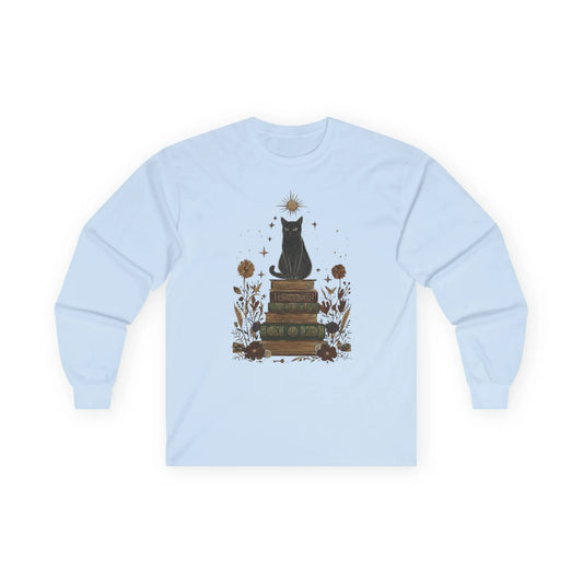 Mystic Cat & Books Long Sleeve features a celestial black cat atop vintage books with star and floral accents, perfect for book lovers.