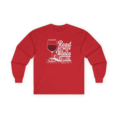 Read Between the Wines Long Sleeve in red, featuring a wine glass and book illustration, cozy reading and wine lover gift.