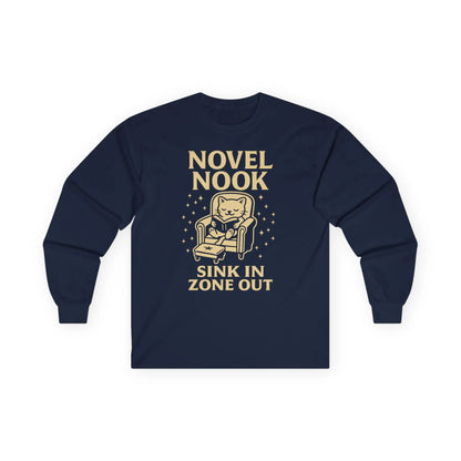 Cozy Novel Nook Long Sleeve shirt with a cat in an armchair, saying 'Sink In Zone Out'—the perfect gift for book lovers!