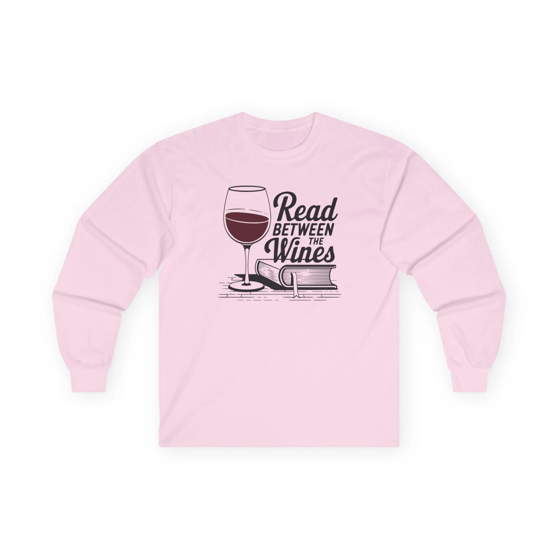 Read Between the Wines Long Sleeve in pink, cozy long sleeve shirt for book lovers with wine glass and book graphic.