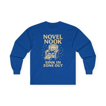 Novel Nook Long Sleeve shirt featuring a cozy cat in an armchair with 'Sink In Zone Out' text, perfect gift for book lovers.