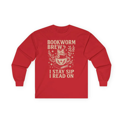 Cozy red long sleeve t-shirt featuring a cat in a cup with ‘Bookworm Brew’ and ‘I stay sip, I read on’ text. Perfect for book lovers.