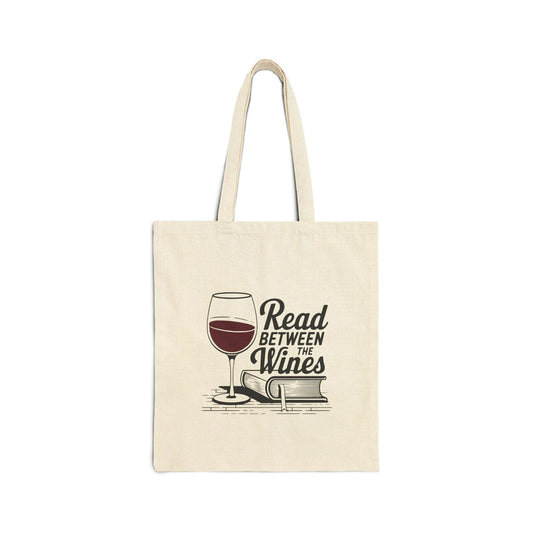 Read Between the Wines Tote Bag featuring a wine glass above stacked books, perfect for cozy reading moments and a glass of red.