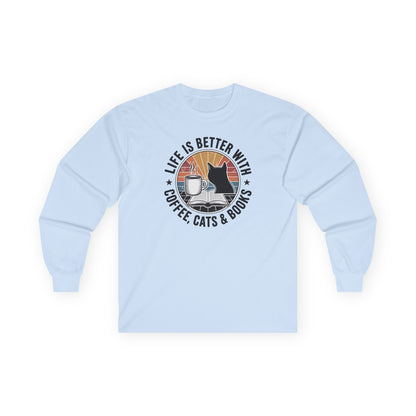 Sunset Reads & Whiskers Long Sleeve featuring coffee, cats, and books graphic on a light blue long-sleeve tee.