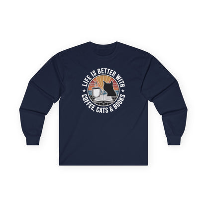 Sunset Reads & Whiskers Long Sleeve featuring coffee, cats, and books design on a navy long sleeve shirt for book lovers.